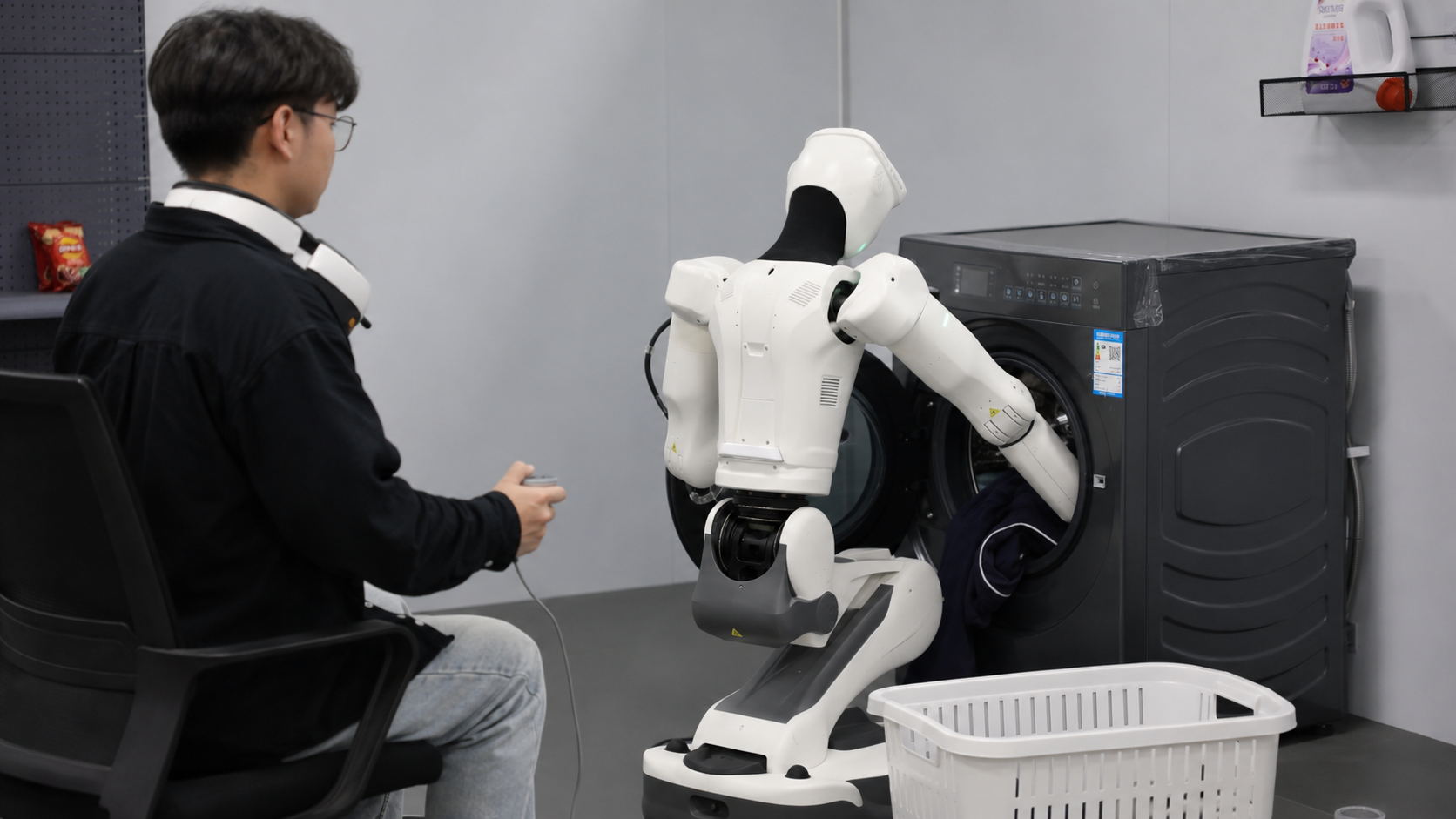 Researcher observing a humanoid robot loading laundry into a washing machine in a test lab