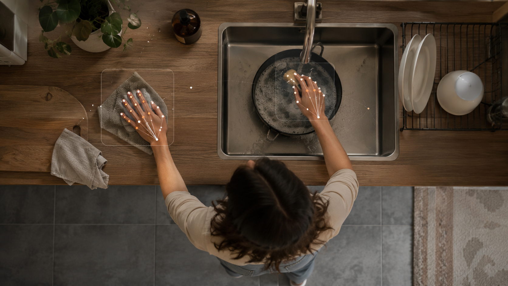 Overhead view of a person washing dishes with hand-tracking data points overlaid